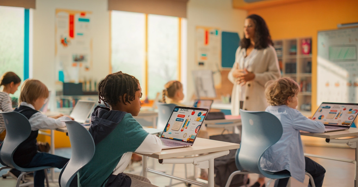 students learning on a laptop in a classroom