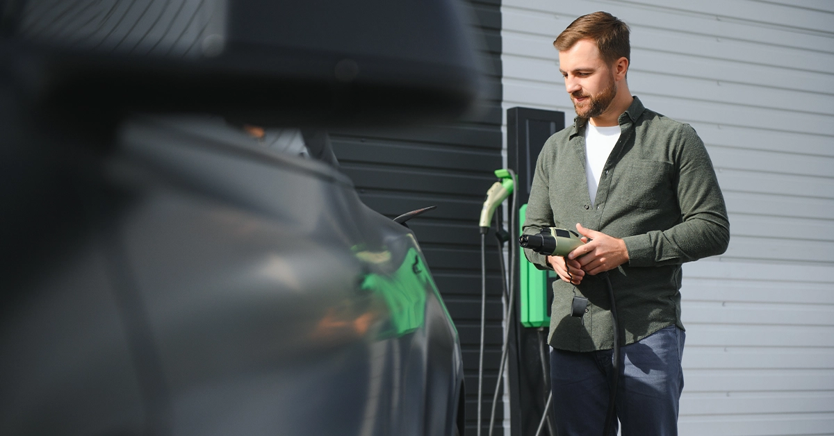 A motorist powering up his vehicle at one of the best electric car charging stations in Abu Dhabi