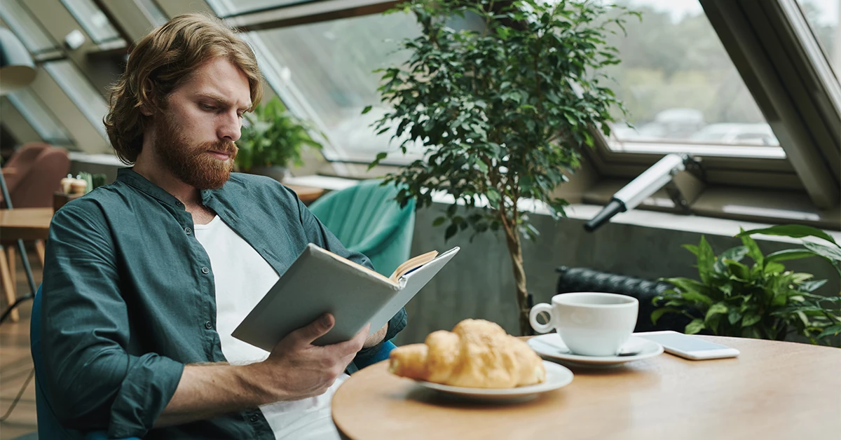 A man reading a book in Tucano Coffee 