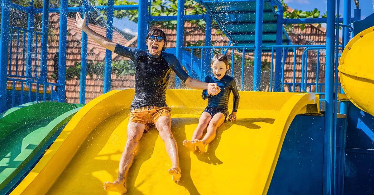 Father and son on a water slide