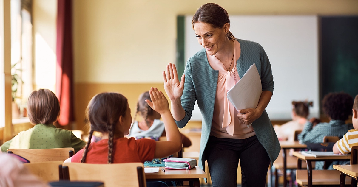 A teacher interacting with a student in school