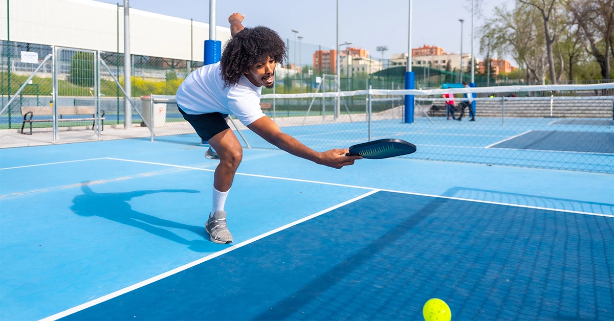Boys playing tennis at a Padel Court in Sharjah