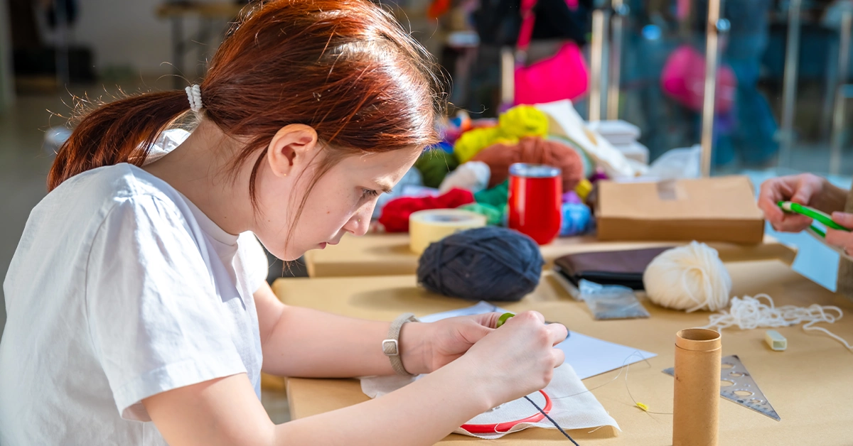 A girl learning embroidery in art center