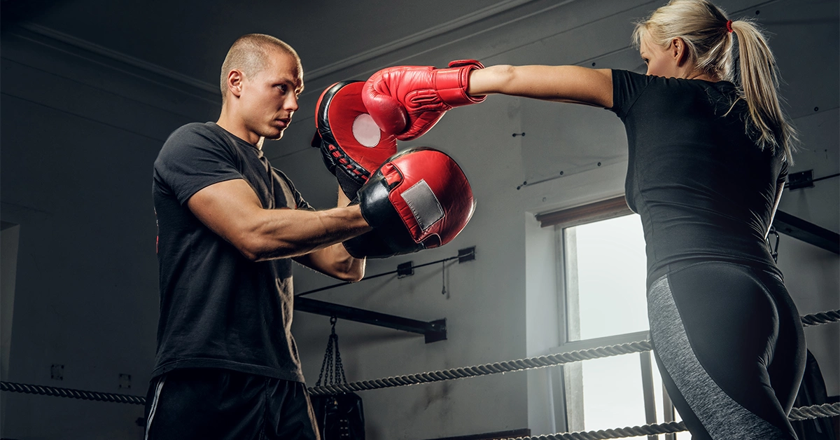 A girl doing boxing drill at a gym in Al Deira