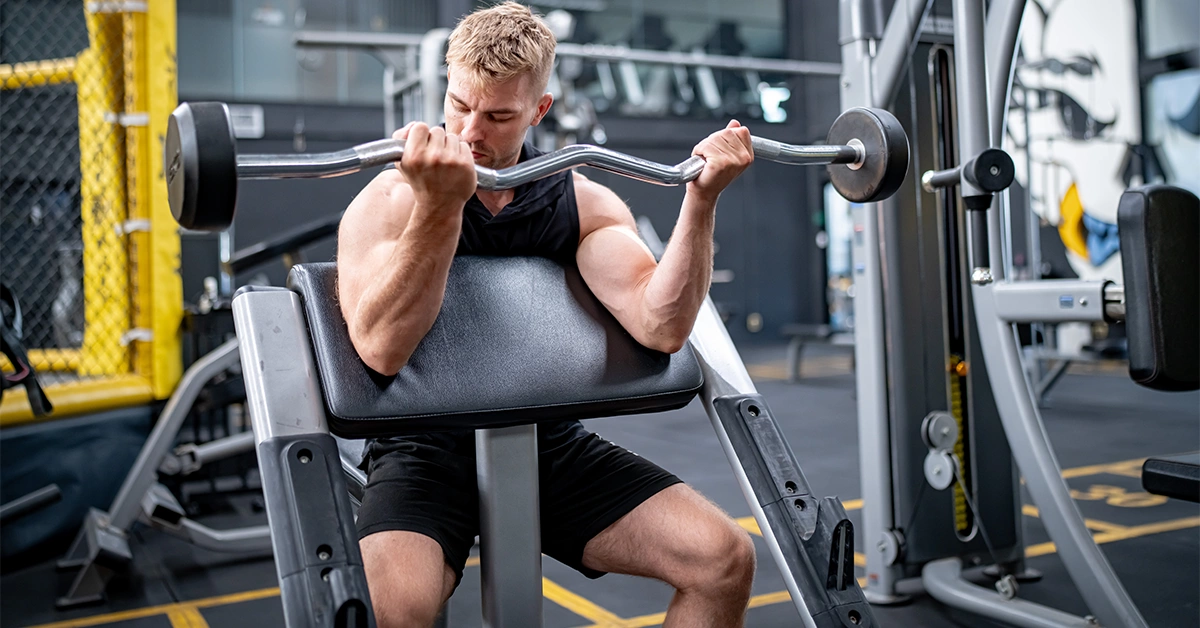 A man weightlifting at a gym in Dubai Investment Park