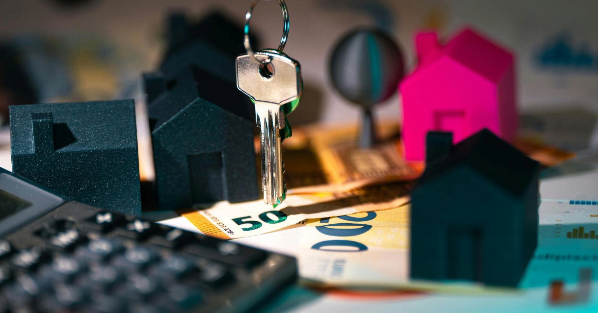 Real estate finances with keys and model houses
