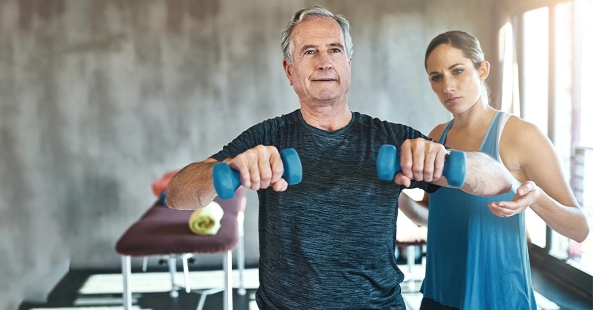 Man working out with the help of a personal trainer