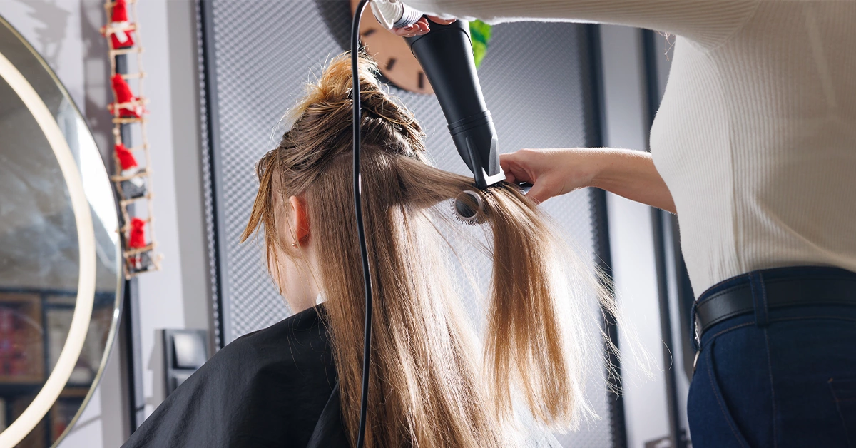 A hairdresser styling a client’s hair in a salon