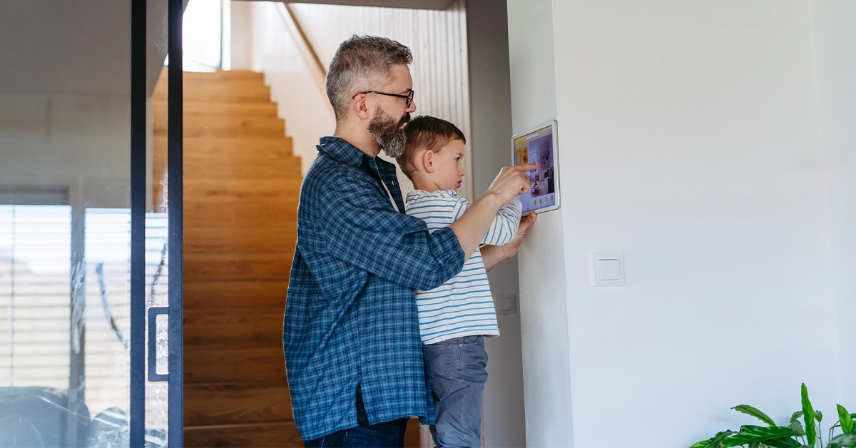 A father showing his son smart home devices 