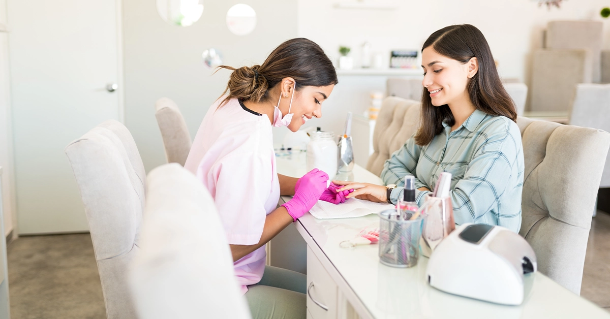A nail expert decorating nails in a ladies’ beauty salon in Deira, Dubai