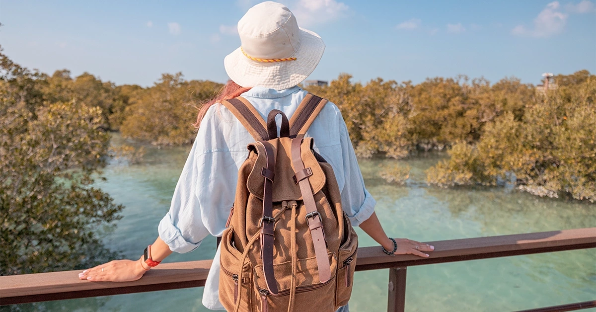 A woman enjoying a scenic walk at Al Mugheirah Bay