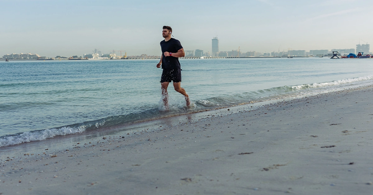 A man jogging at Dubai Mercato Beach
