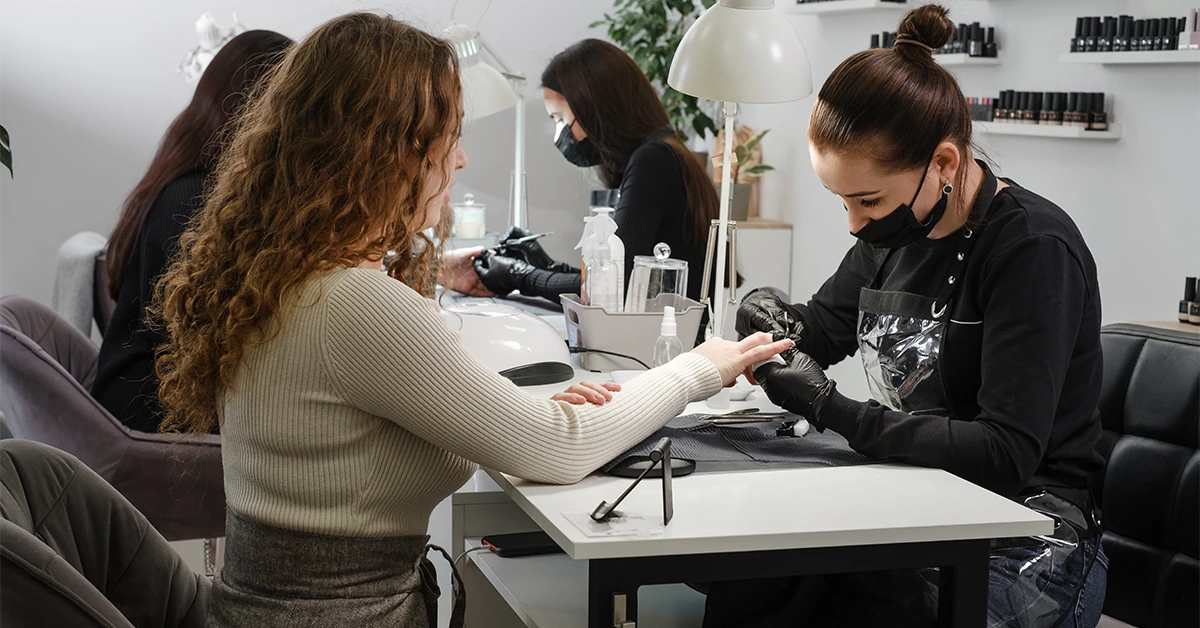 A girl getting a manicure in a beauty salon in Karama