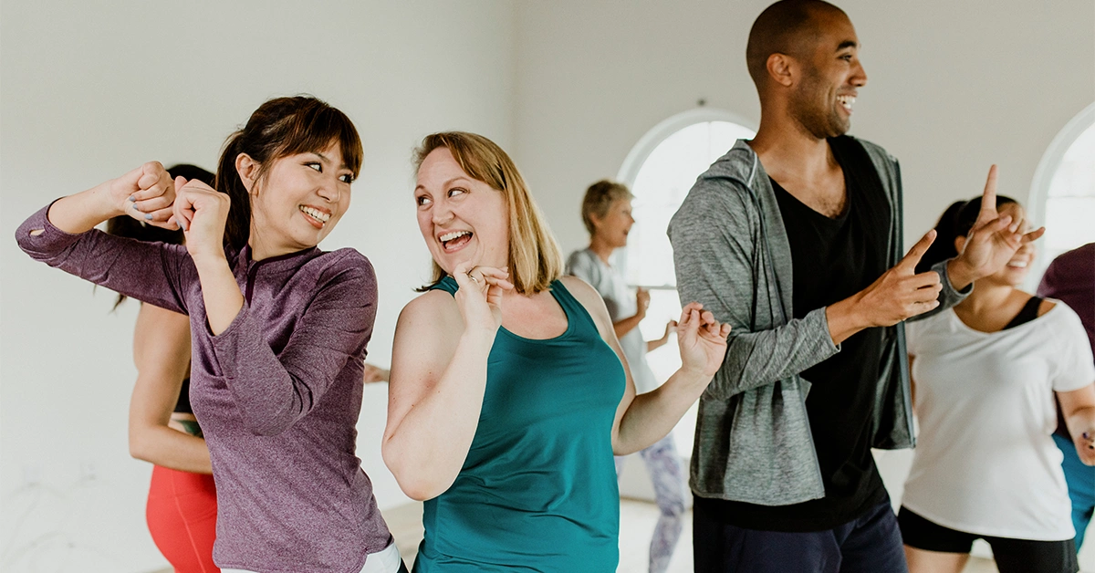 People practicing zumba class by face off gym