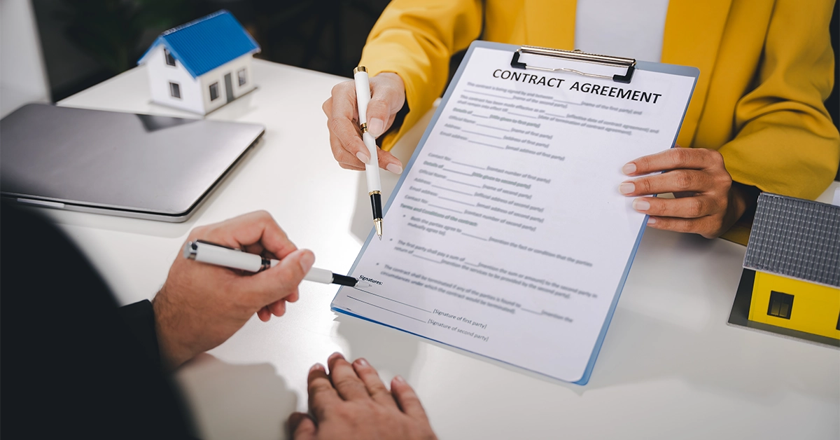 A tenant signing a Umm Al Quwain rental contract