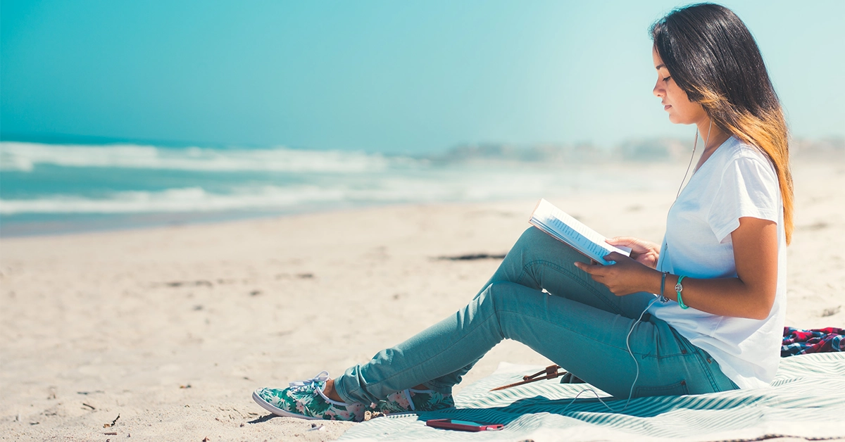 A girl reading a book at Mercato Beach Dubai