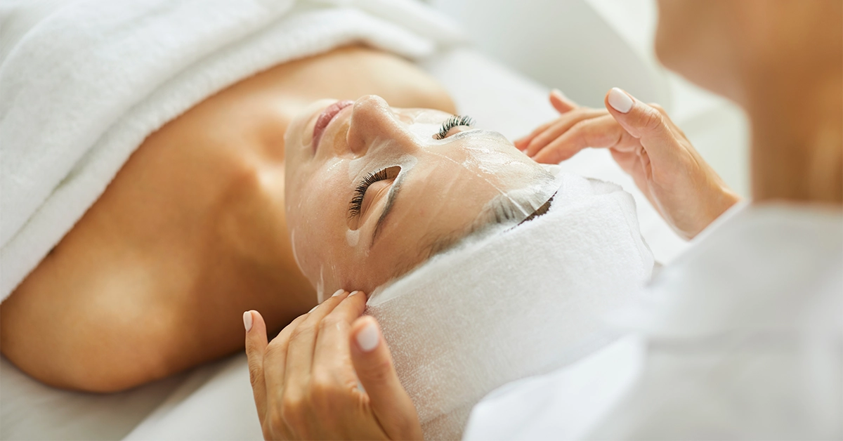 Female Beautician Applying Mask on a Client