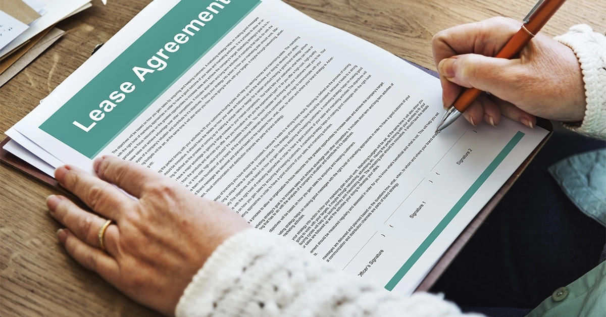 A man signing a tenancy contract