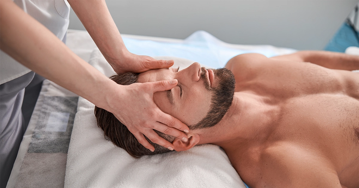 A man enjoying a head massage in a spa in DIP 