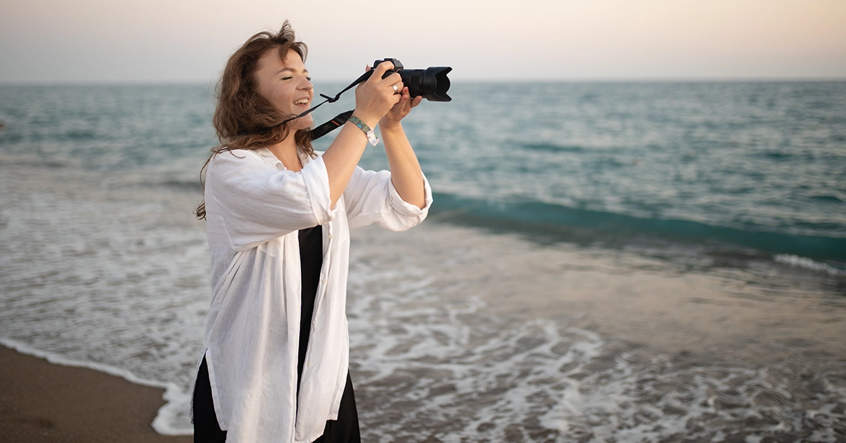 A woman taking pictures at Dubai Mercato Beach