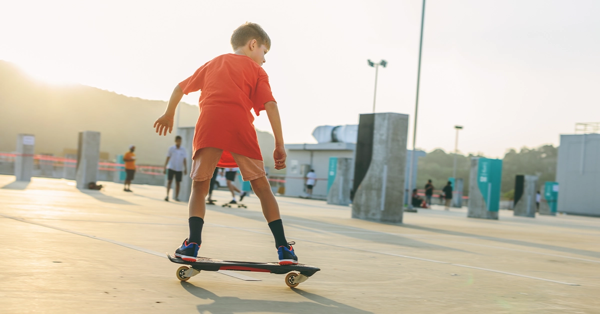 A boy taking skating lessons at X Dubai Skate Park)