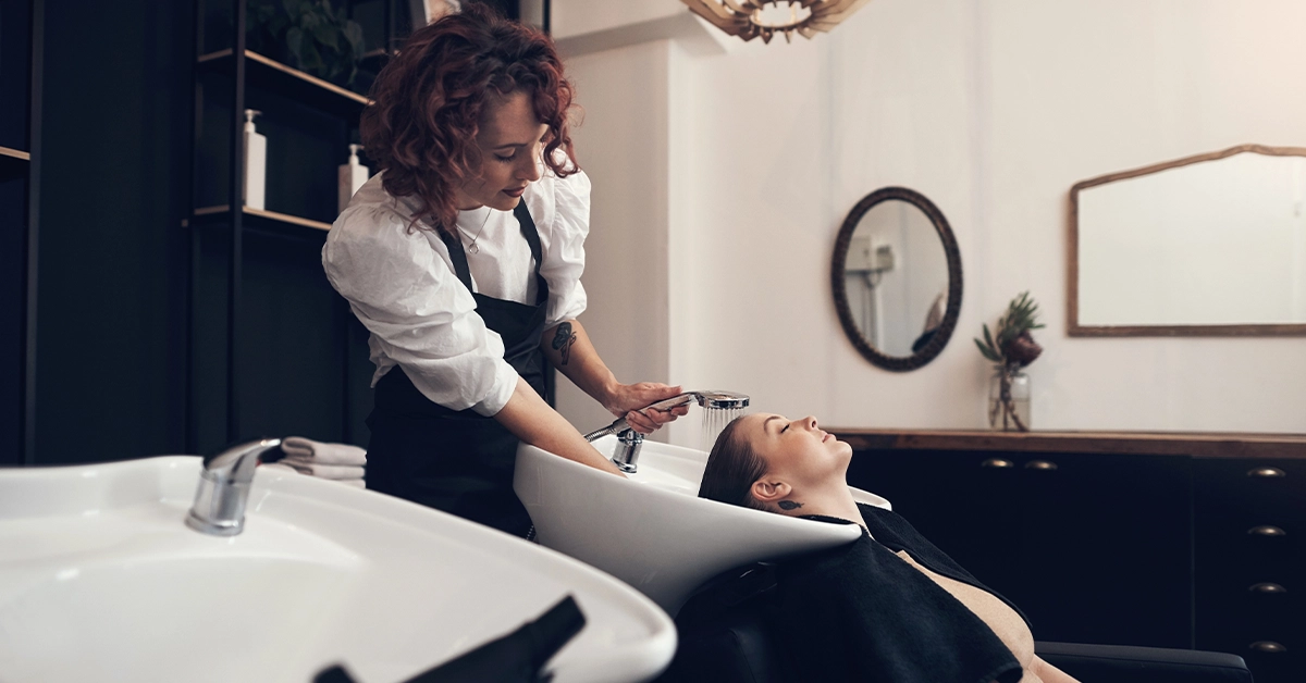A woman washing a client’s hair
