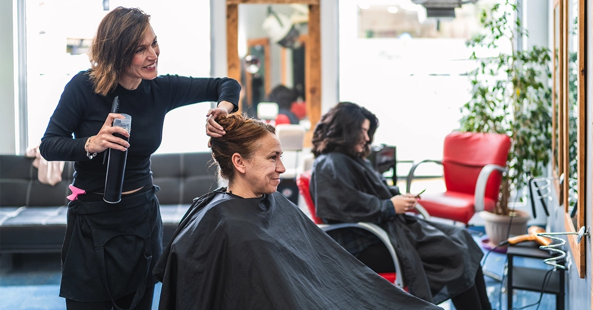 Hairdresser with her client