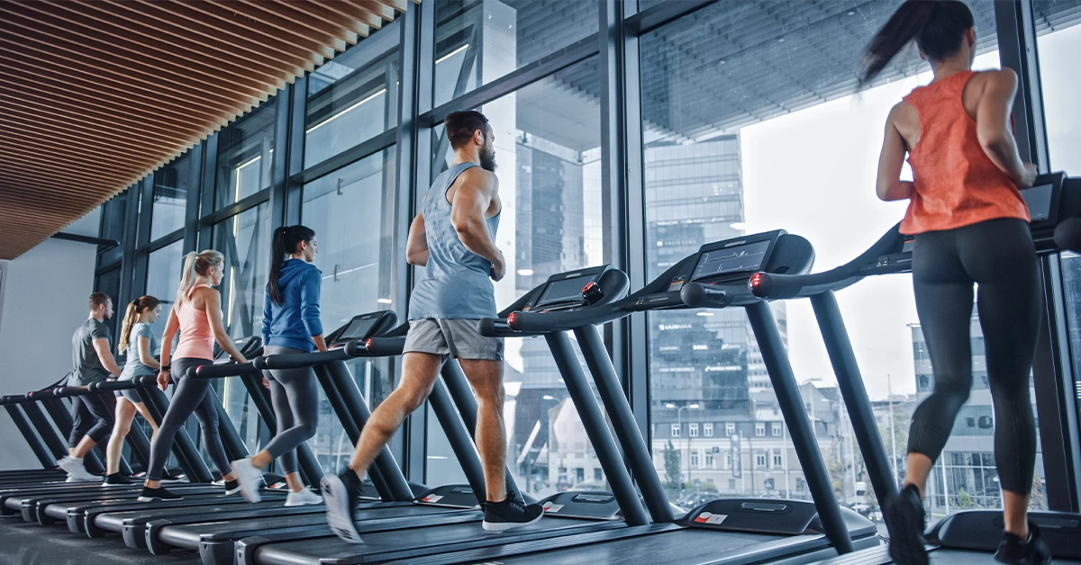 Gym members running on a treadmill at Nero gym in Khalifa City