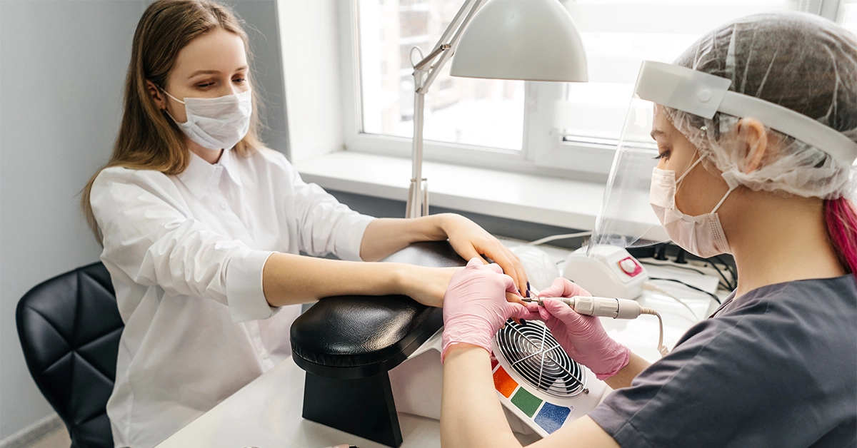 A woman getting a manicure at a beauty salon
