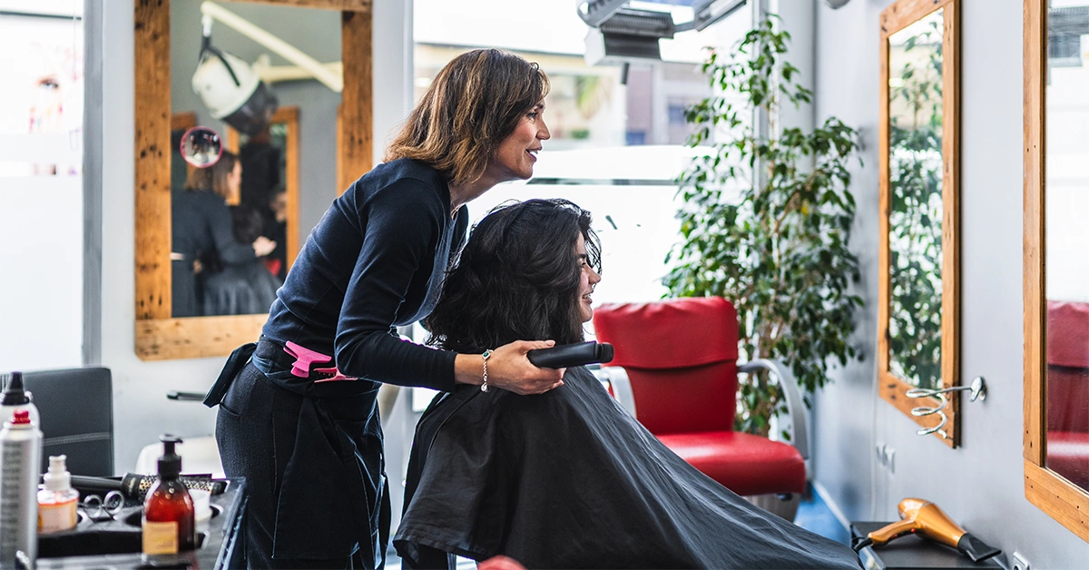 A hairdresser styling a client's hair