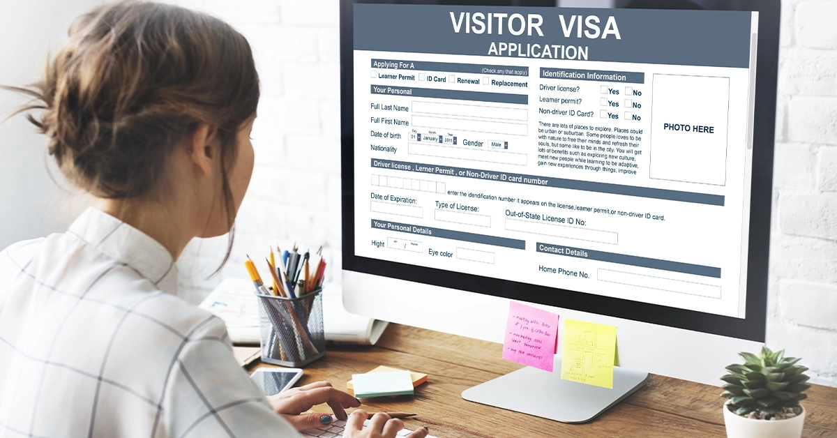 A woman filling out an online visa application form