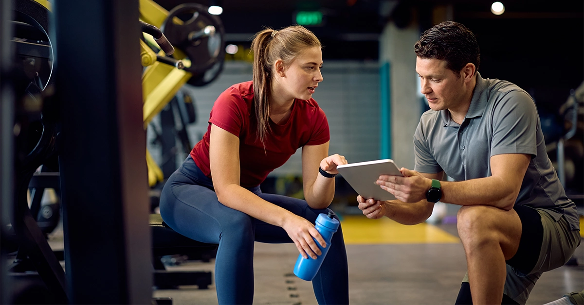An instructor customising a fitness plan for a young athlete