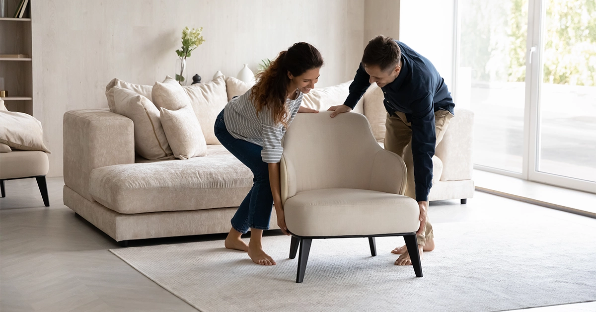 Couple Carrying Modern Armchair