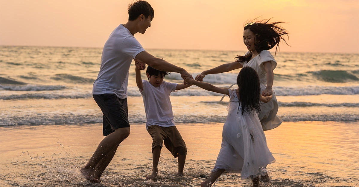A young family enjoying vacation on a beach