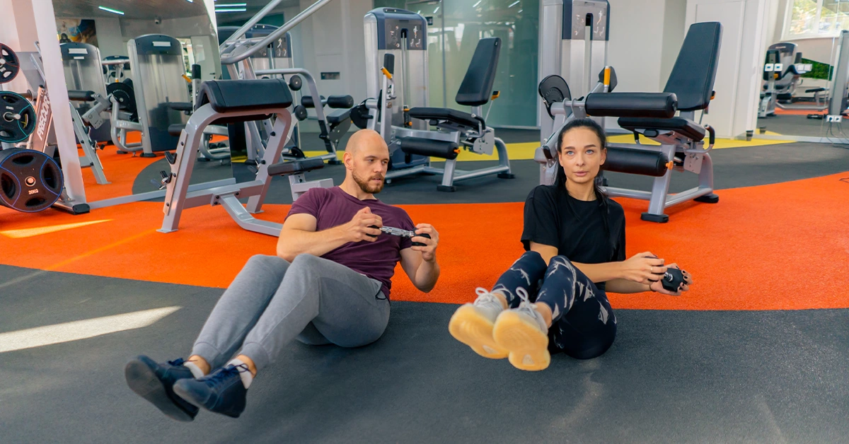 A personal trainer providing classes to a man at the best gym in Karama