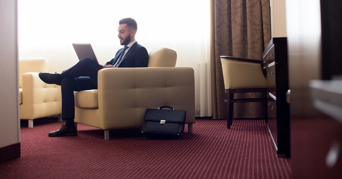 A young businessman working in a hotel room