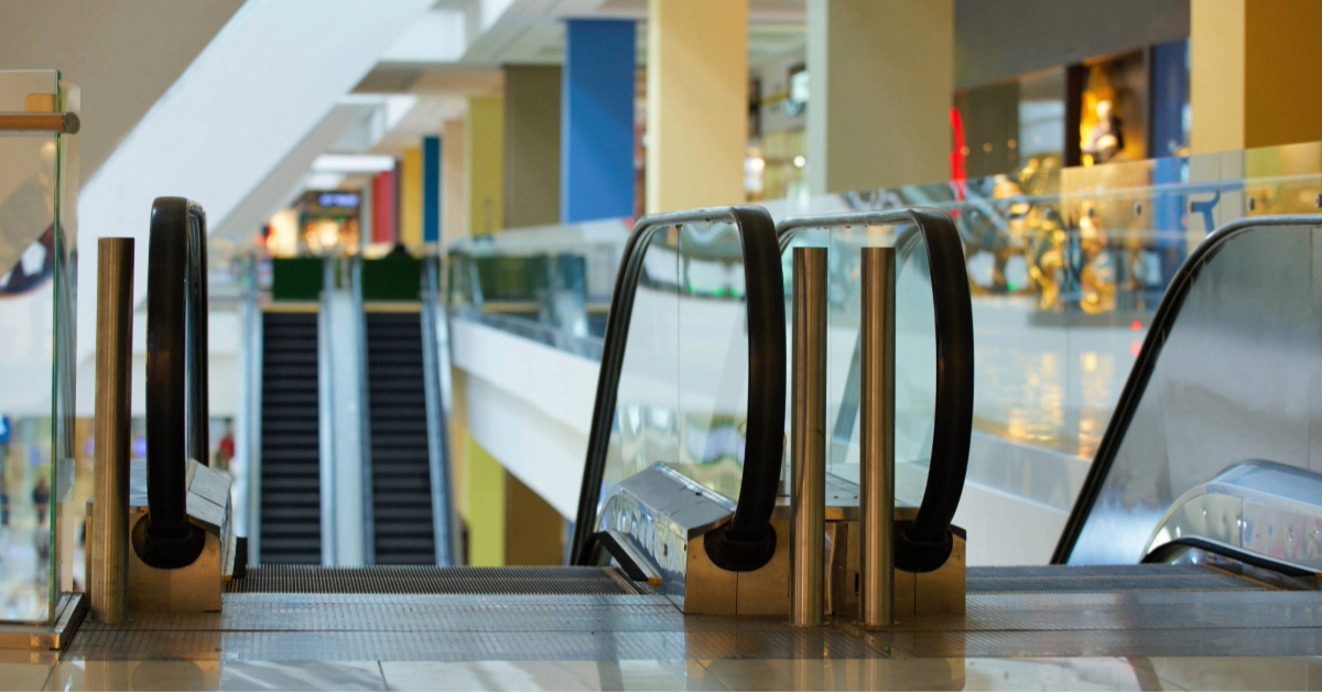 two escalators inside a shopping mall
