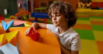 Kid playing in the orange wheels entertainment zone