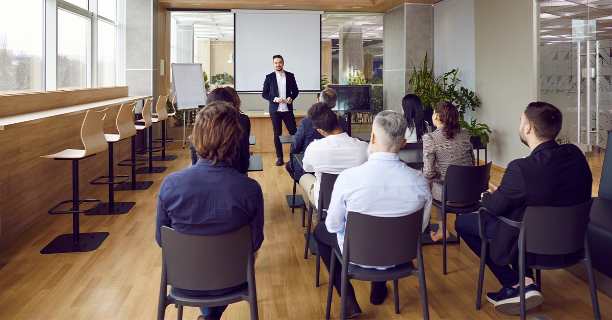 A professional business coach delivering a lecture at one of the top business schools in Dubai