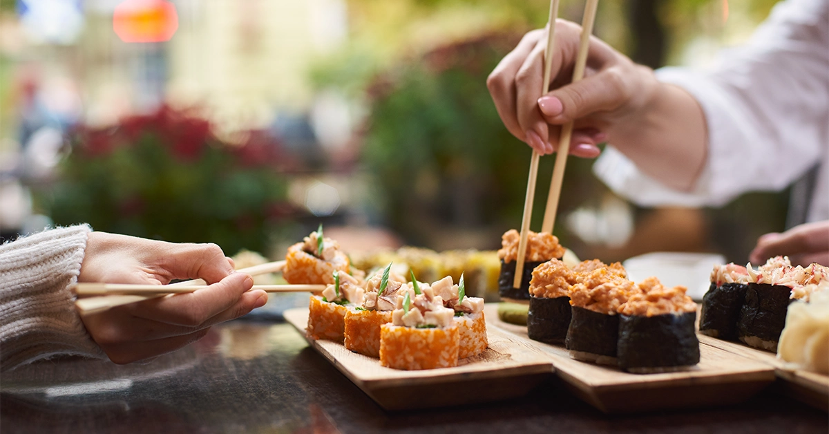 People having sushi at Sumo Sushi & Bento Al Qasba