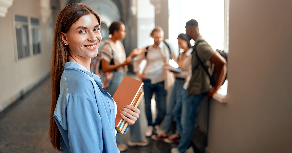 University Girl With Books in a Corridor