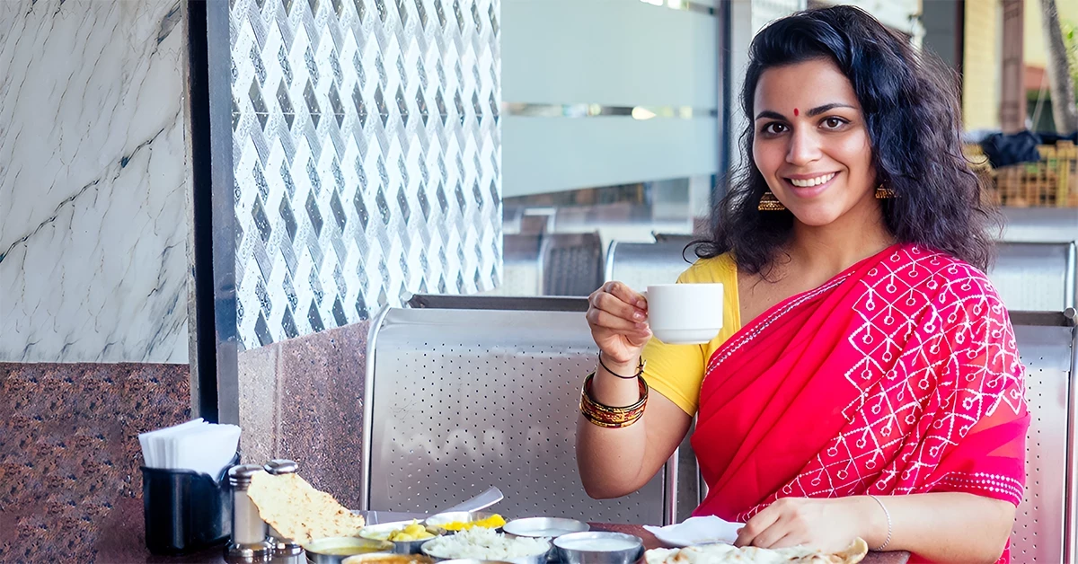 A woman enjoying food at one of the best Indian restaurants in Business Bay 