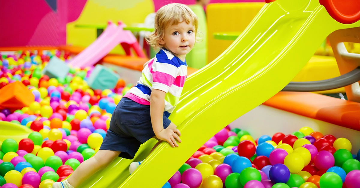 Girl enjoying soft play area at Orange wheels