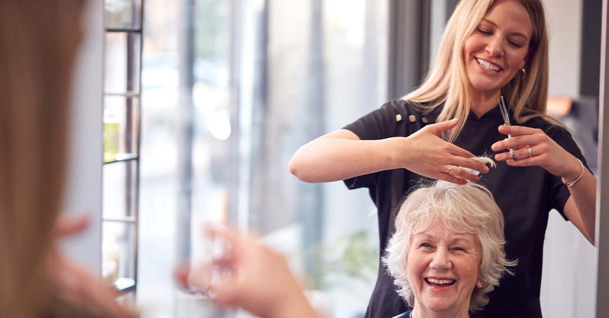 Woman having a haircut at Robert Alexander salon, barsha heights