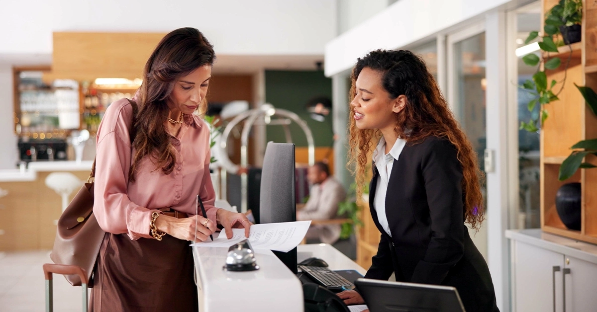 Lady Signing a Form at the Hotel Reception