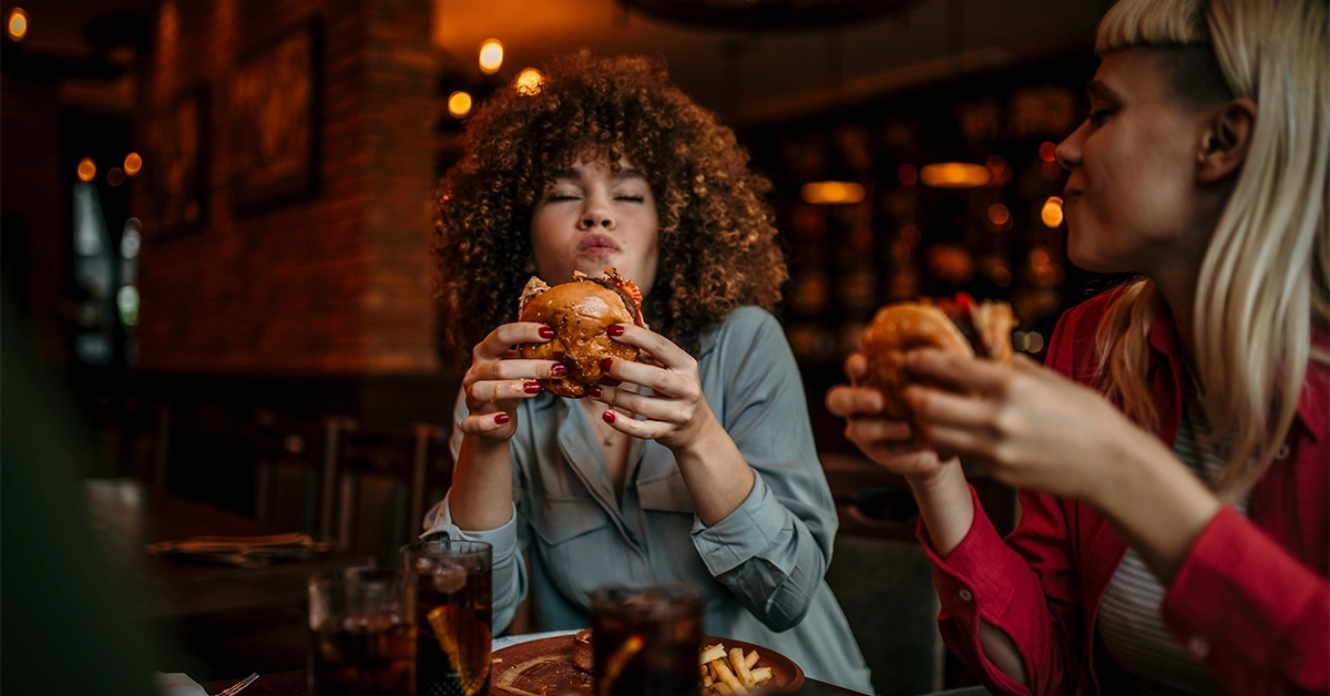 Two Friends Eating Burgers