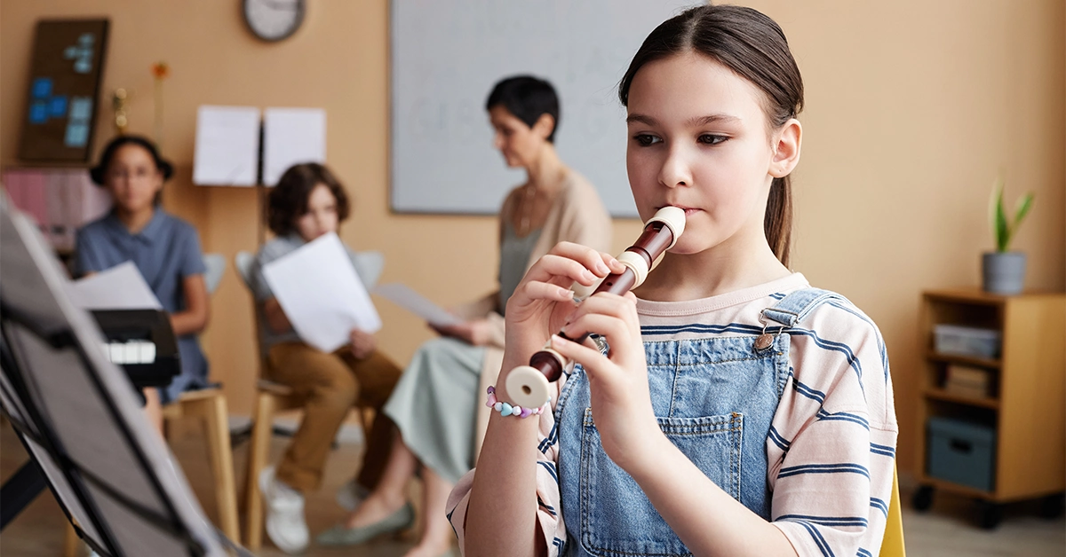 A girl learning to play the flute