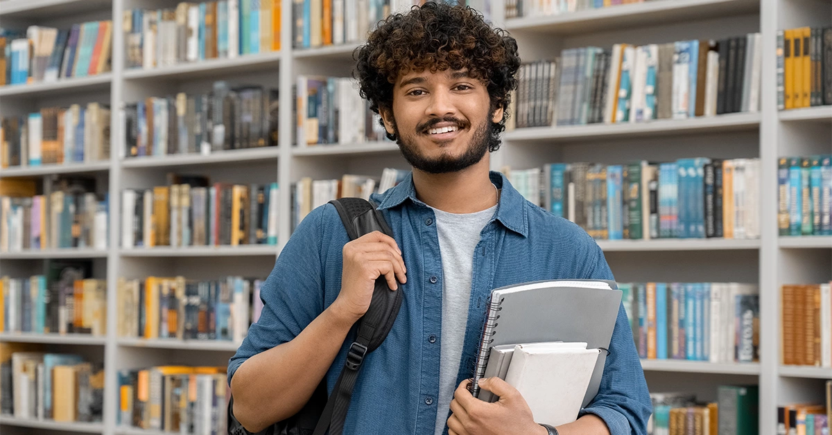 A student borrowing books from a library