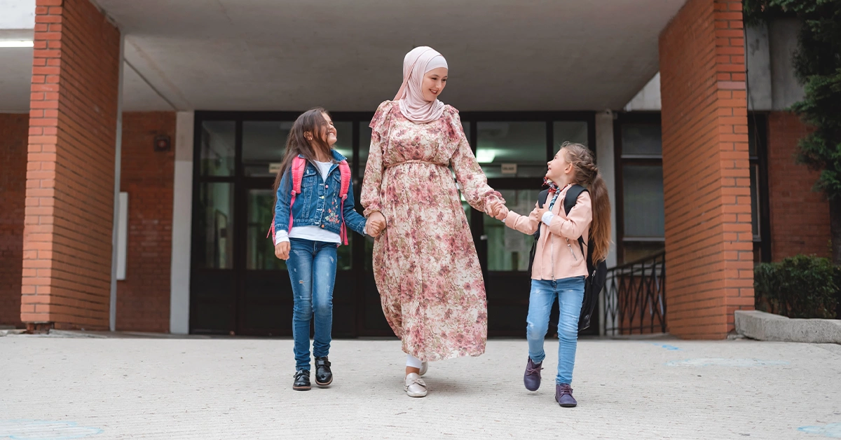 A Muslim mother dropping her kids off at school