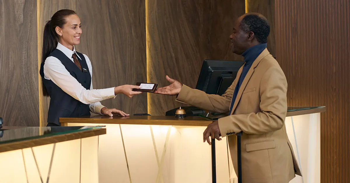 Receptionist Giving Key to the Guest